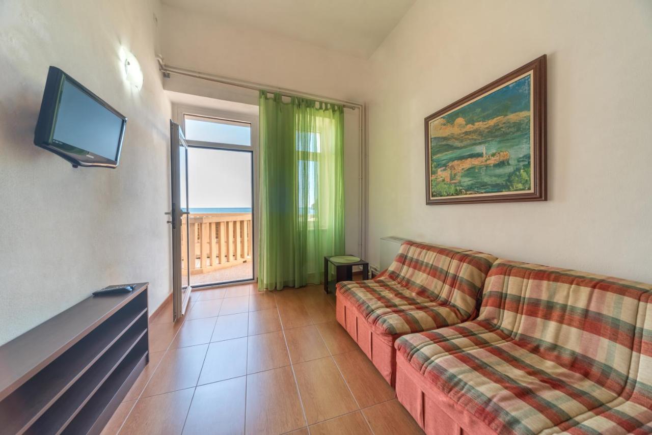 Seating area beside a window at R Club Apartments Budva