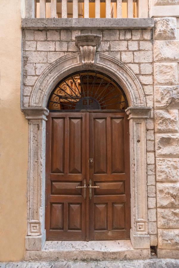 Historic wooden door in a stone building in Budva Old Town