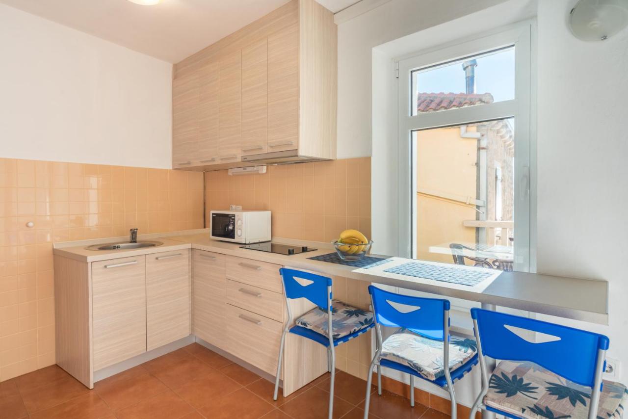 Kitchen counter with blue chairs at R Club Apartments Budva
