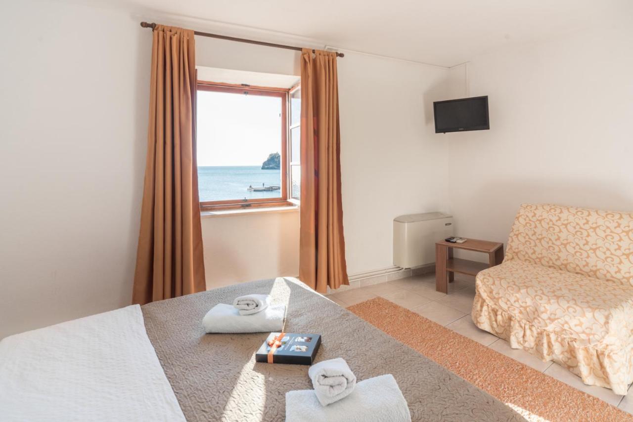 Bedroom with sea-facing window at R Club Apartments Old Town Budva