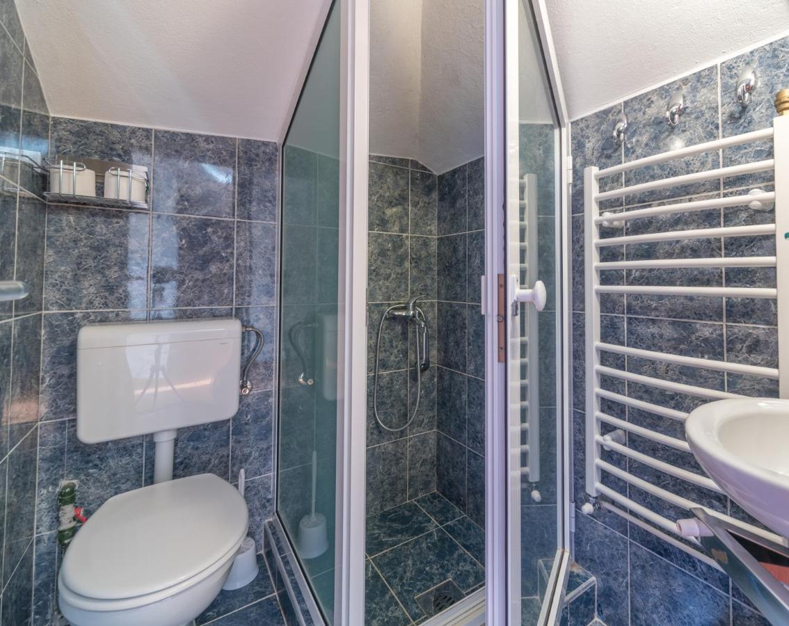 Bathroom with walk-in shower at R Club Apartments Budva