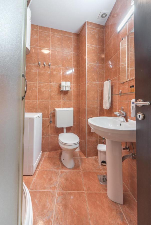 Private bathroom with toilet and sink at R Club Apartments