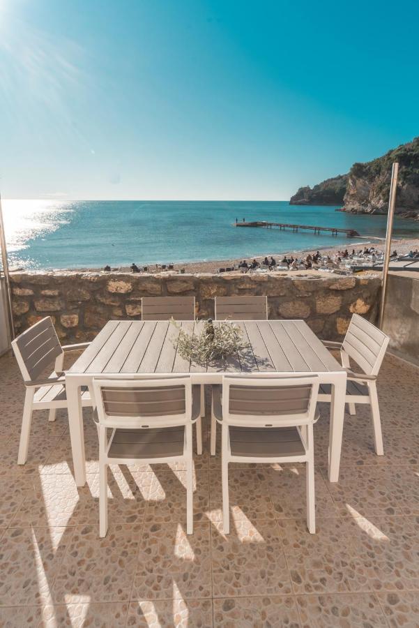 Table and chairs set on the beach near Budva Old Town