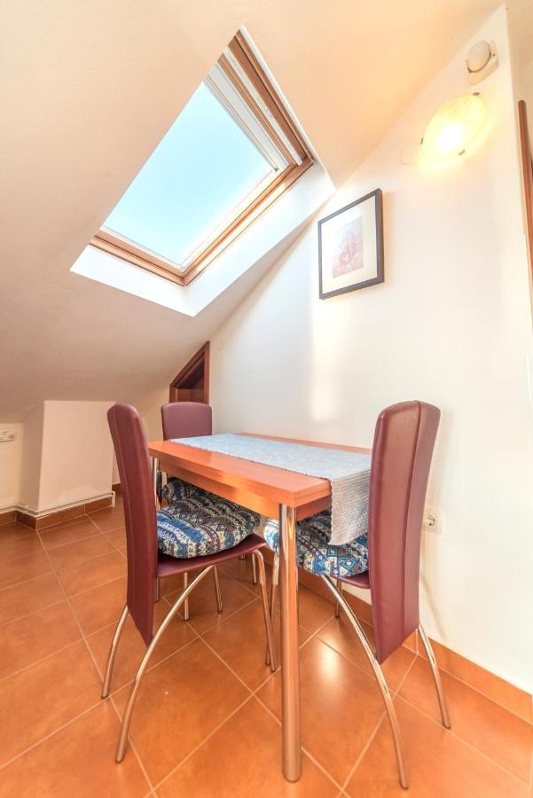Dining table and chairs inside an apartment at R Club Apartments