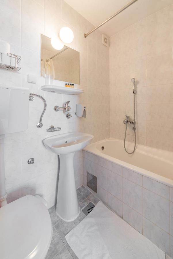 Bathroom with tub and sink at R Club Apartments Old Town Budva
