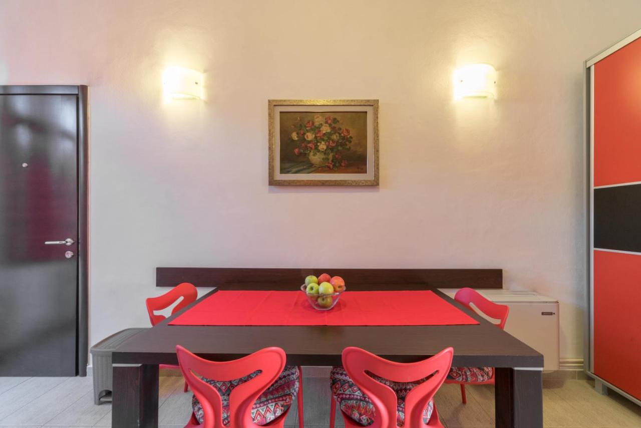 Dining area with red table and chairs at R Club Apartments Budva