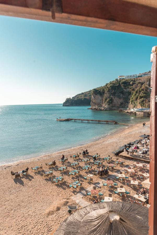 Beach with umbrellas on the Adriatic beside Budva Old Town