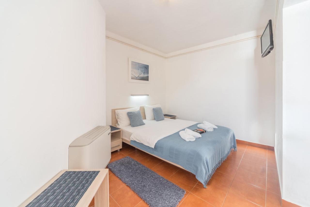 White bedroom with desk at R Club Apartments Old Town Budva