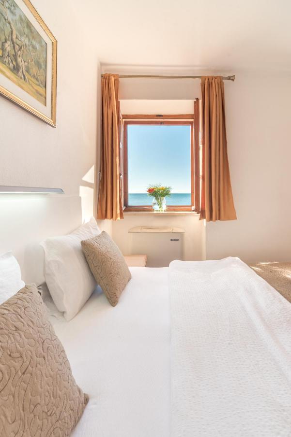 Studio with Sea View at R Club Apartments — twin beds beside a window over the Adriatic