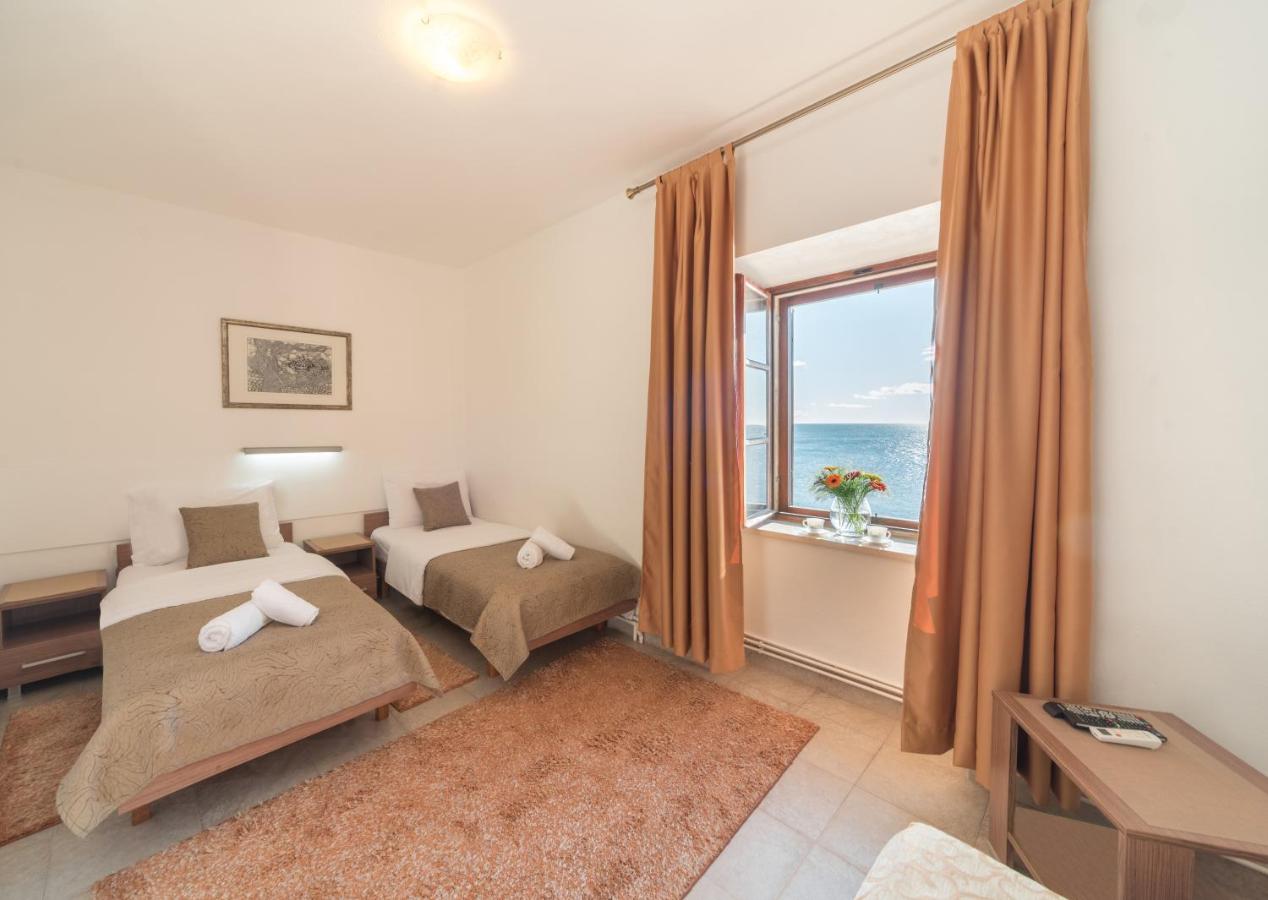 Twin-bed room with window at R Club Apartments Old Town Budva